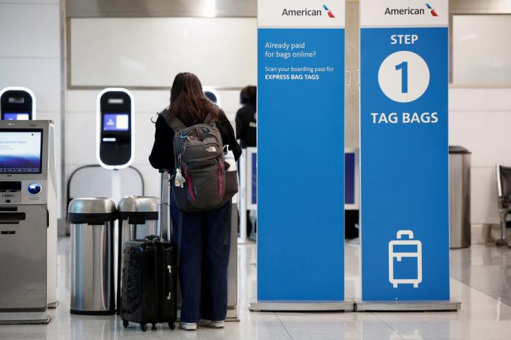 A traveler uses an American Airlines’ screen at Ronald Reagan National Airport (DCA) ahead of the Thanksgiving holiday in Arlington, Virginia