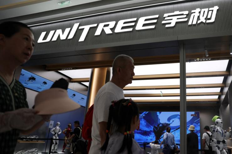 People pass by a Unitree store in Beijing, China