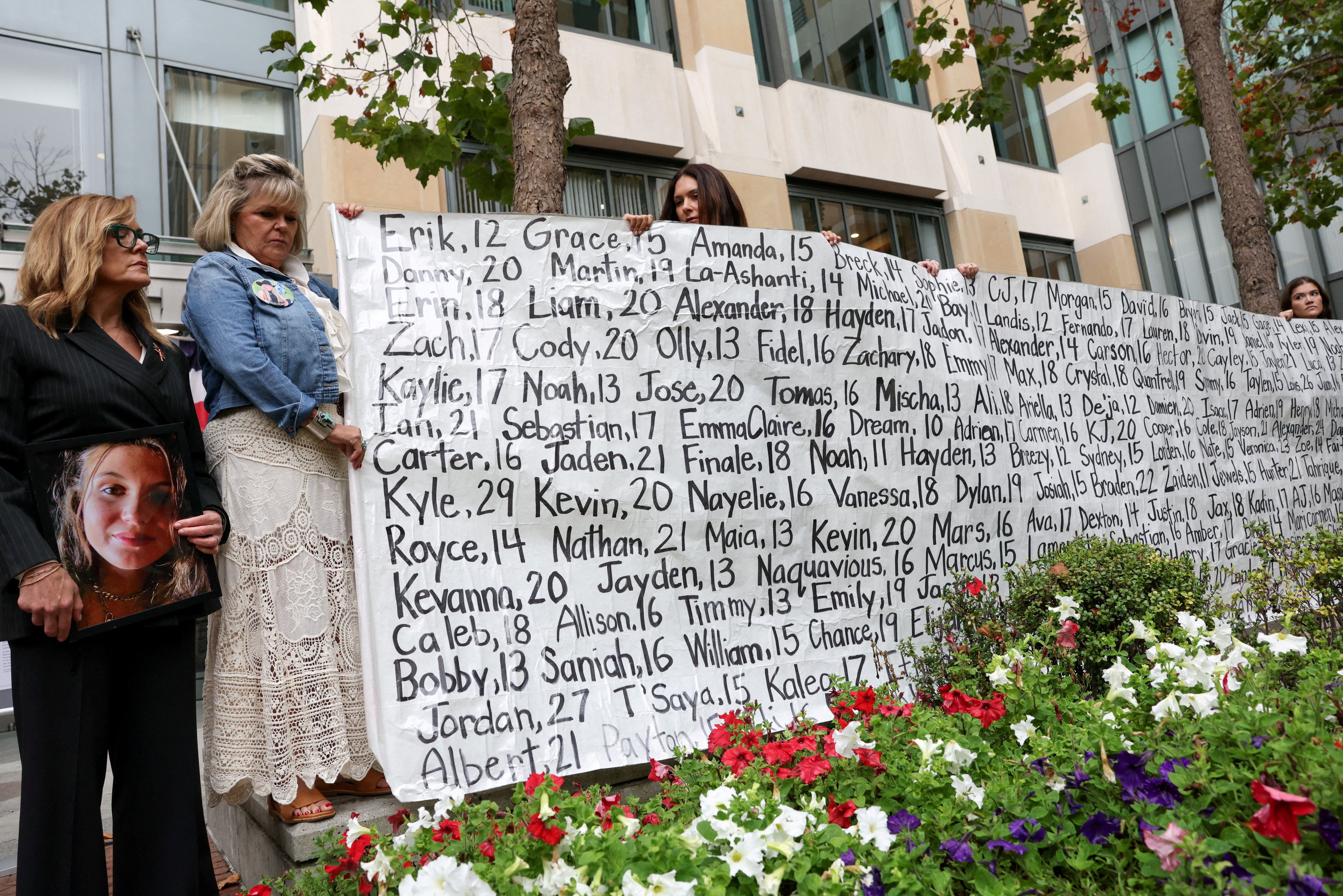 Parents of children and young adults whose deaths were allegedly related to their social media use hold a banner during a press conference, as Meta goes to trial over claims its services harmed young users, in Oakland, California. 