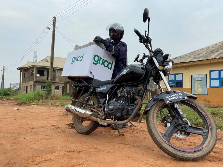 A bike messenger from Nigerian startup Gricd, now called Figorr, packs a cooling box in front of a community hospital in Ogun state on March 24, 2021.