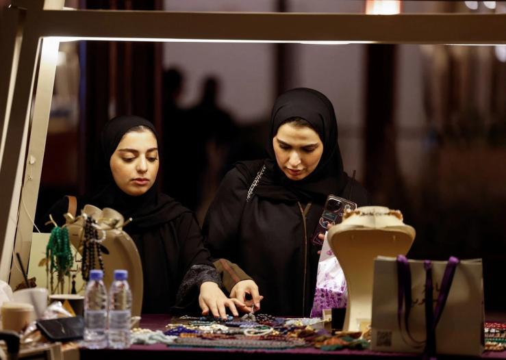Visitors shop at a booth selling jewellery at the Saudi International Handicrafts Week “Banan 2025” in Riyadh, Saudi Arabia, Nov. 16, 2025.