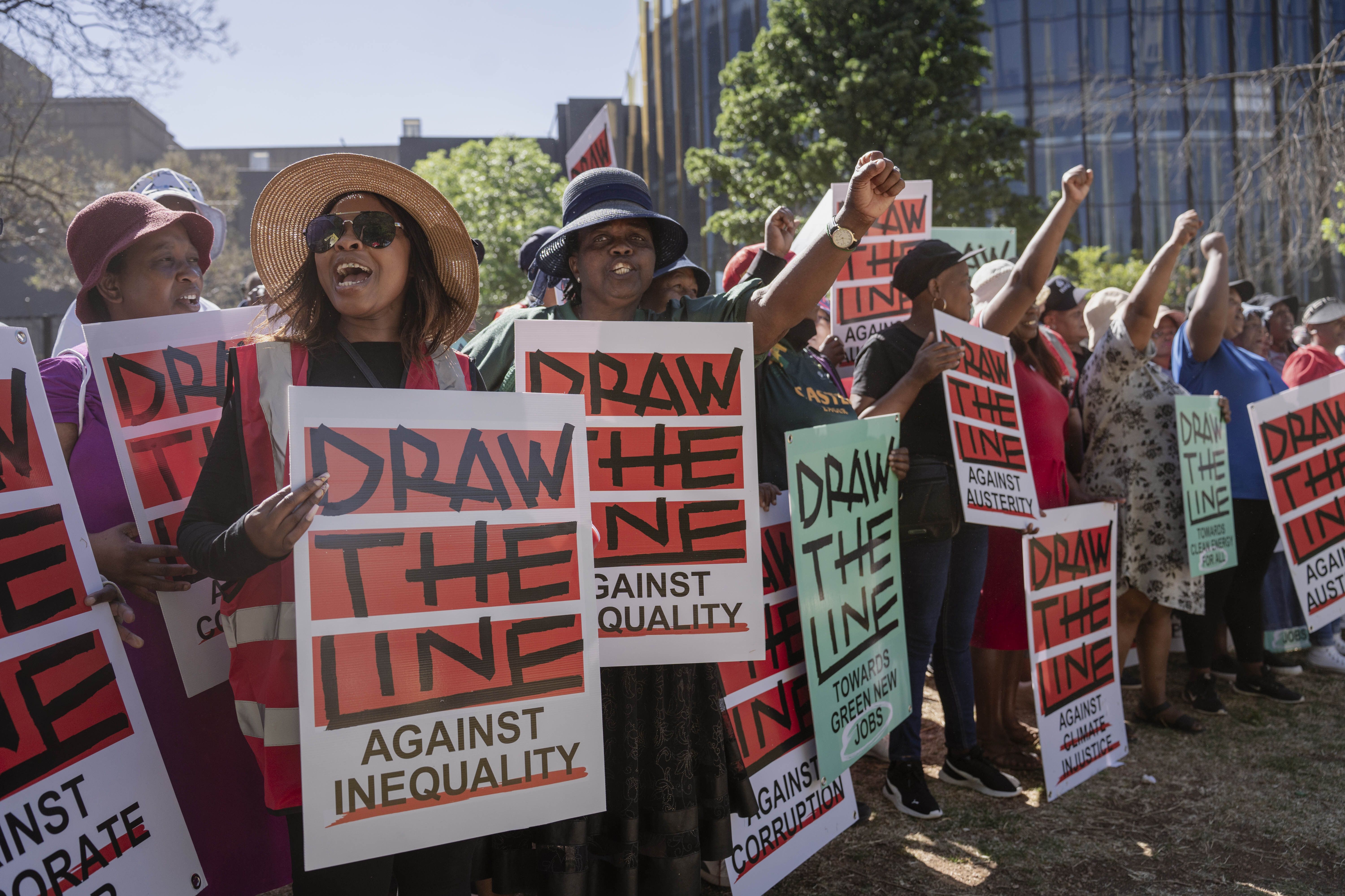 Environmental activists in Johannesburg hold banners reading ‘Take a firm stand against injustice, corruption and inequality.’