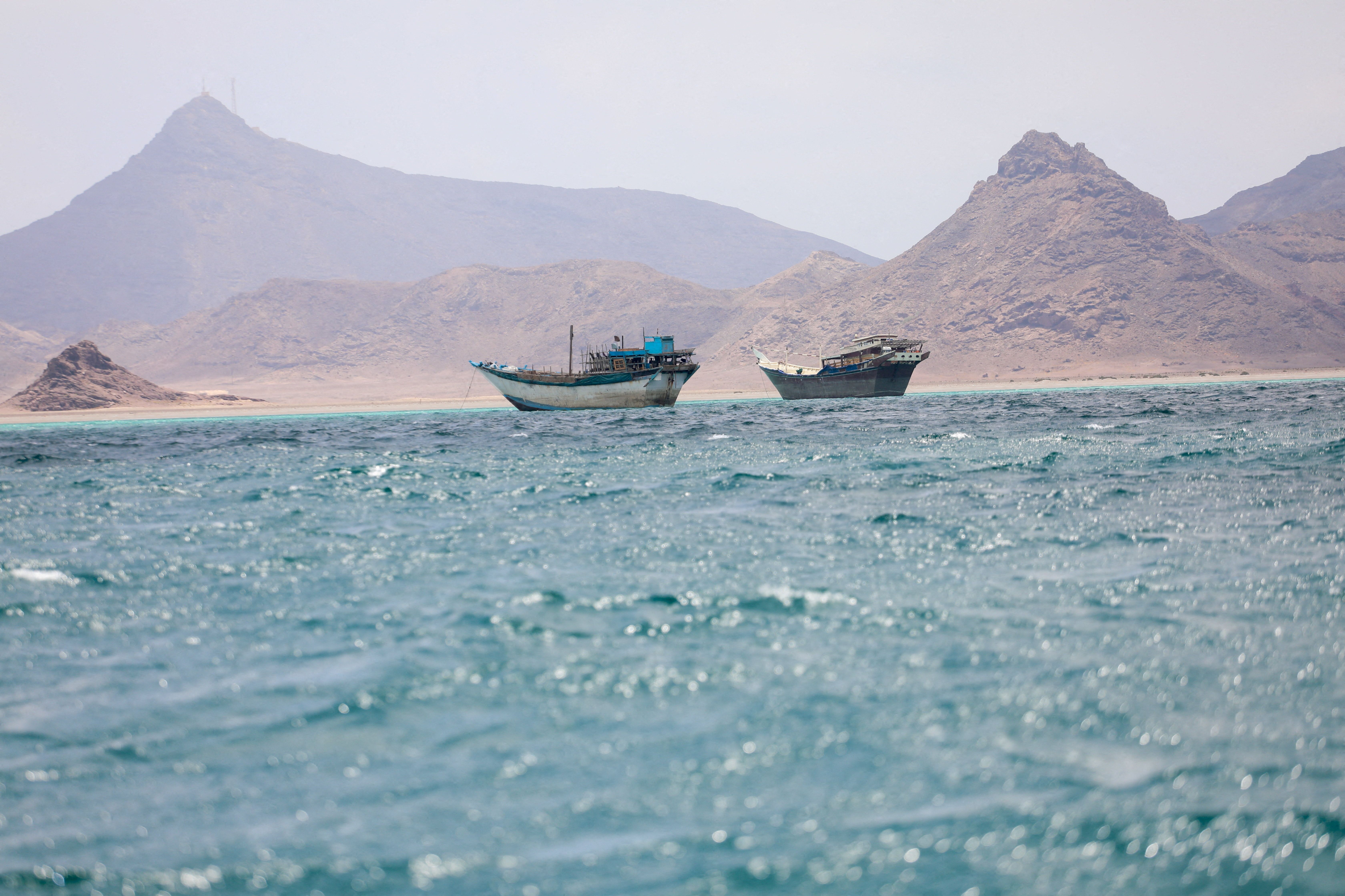 Boats float near the coast of Bab el-Mandeb, Yemen.