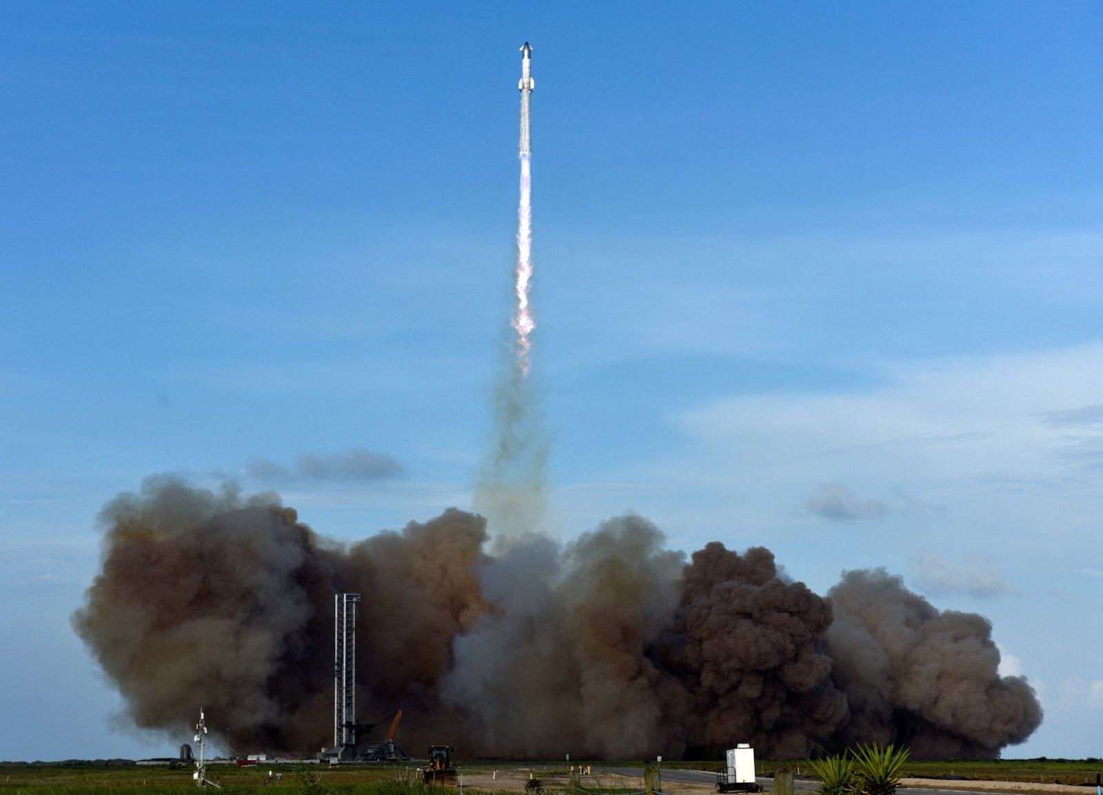 A SpaceX Super Heavy booster carrying the Starship spacecraft lifts off. 
