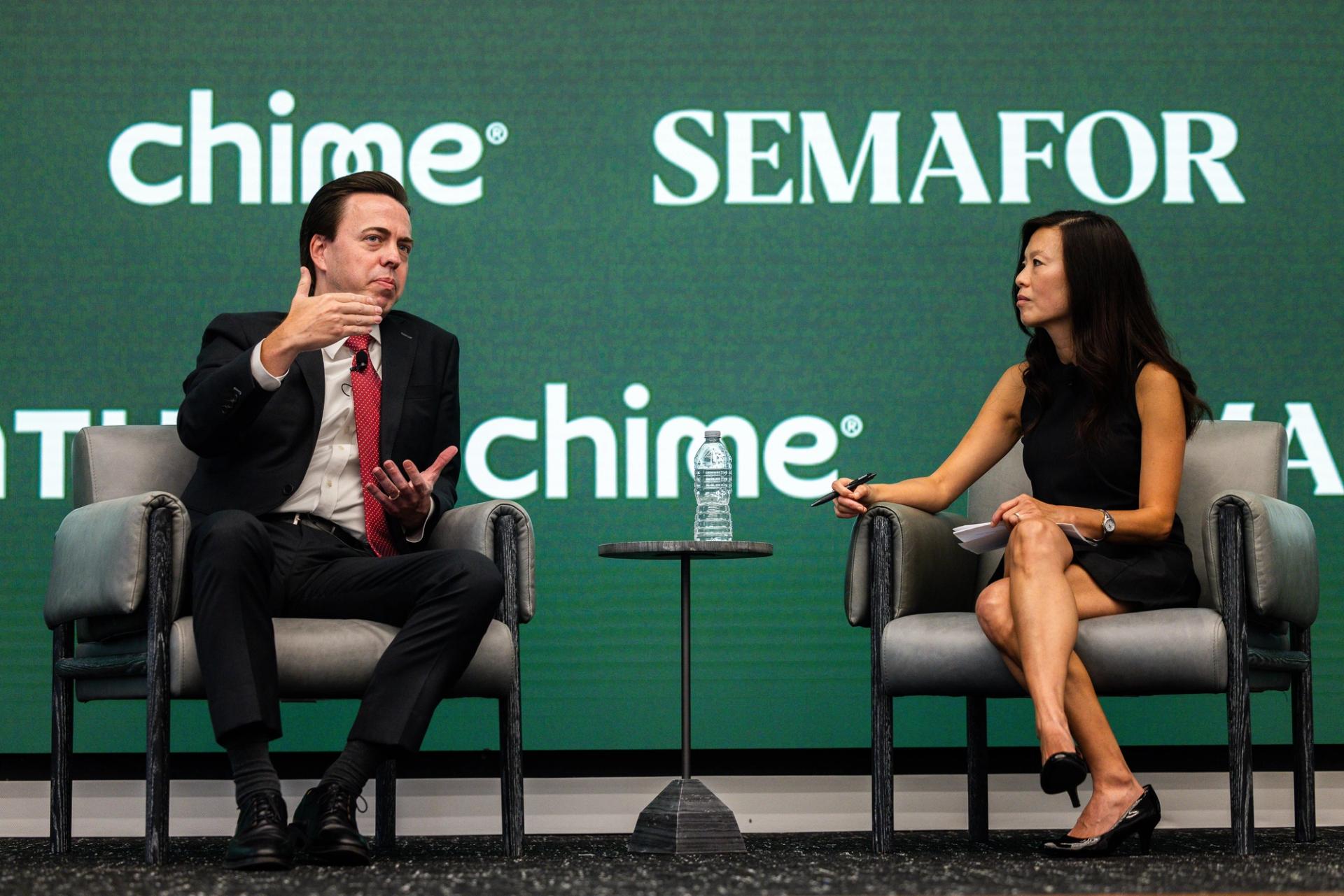 Jonathan McKernan, wearing a dark suit and red tie, speaks to Semafor’s Gina Chon at Semafor’s “Banking on the Future” event in July