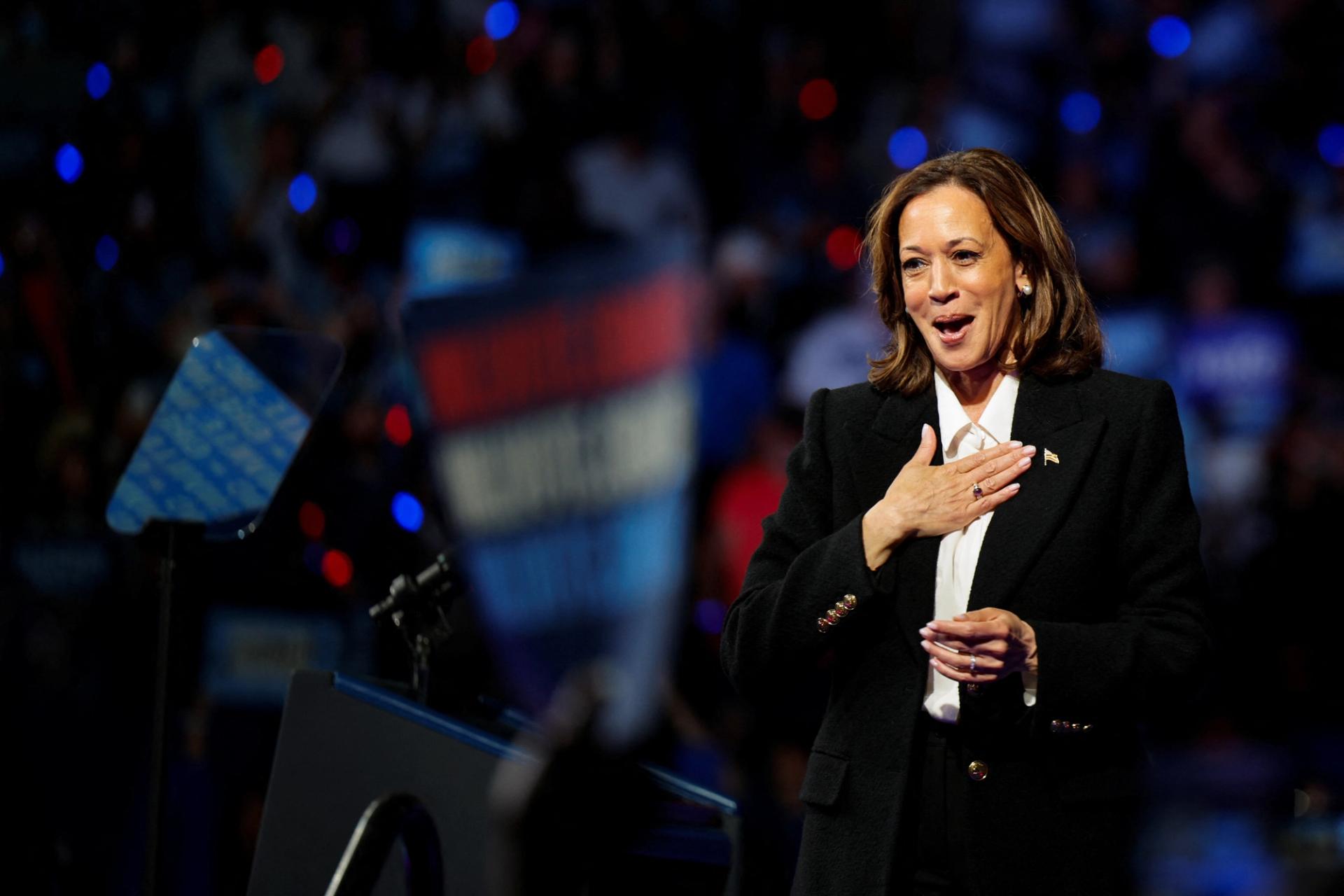 Kamala Harris wearing a dark suit and white shirt at a campaign event at East Carolina University.