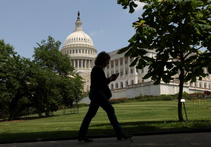 A person walks the grounds of U.S. Capitol.