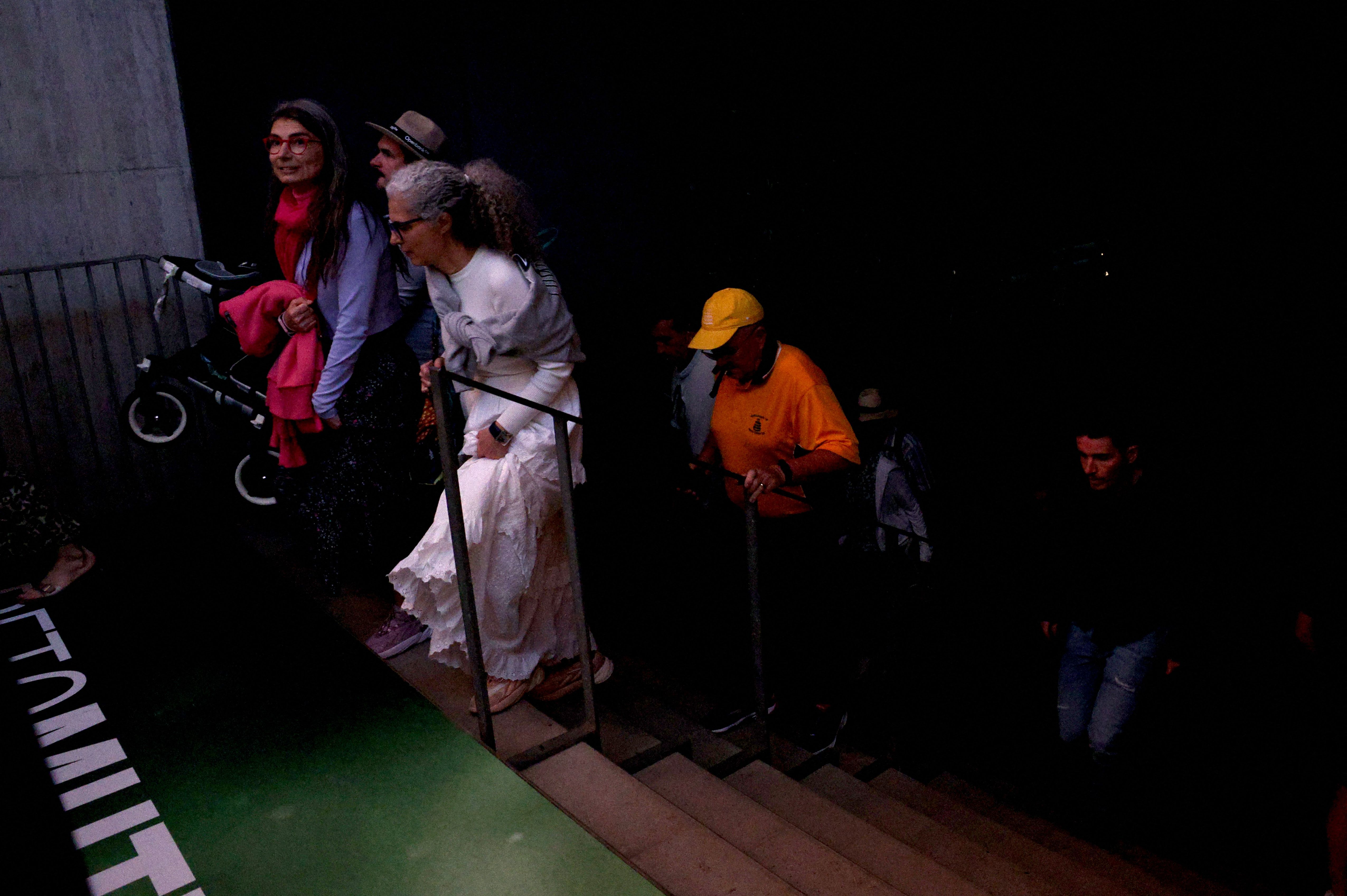 Fans leave the Madrid Open stadium in darkness. 