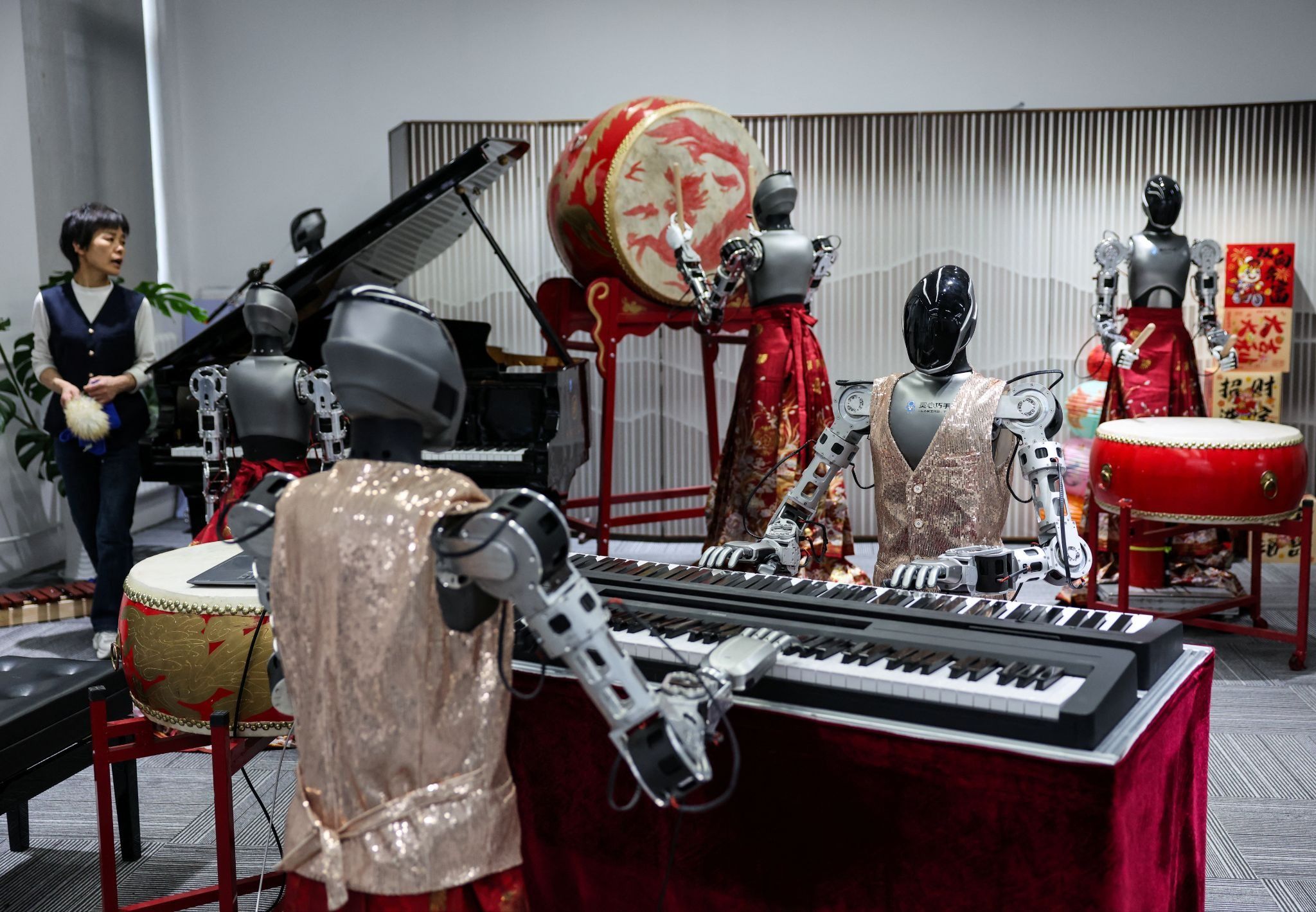 An ensemble of humanoid robots produced by Linkerbot is set up with musical instruments