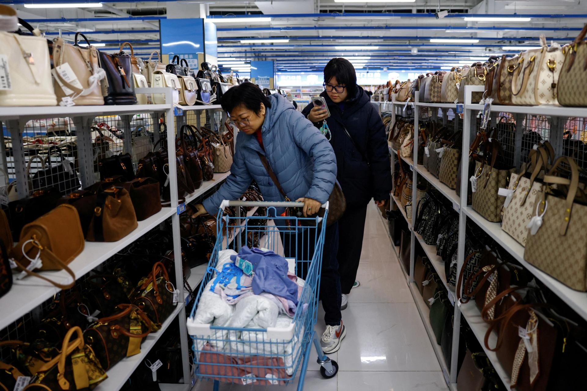 Customers shop for bags at the Wankelai store in Beijing.