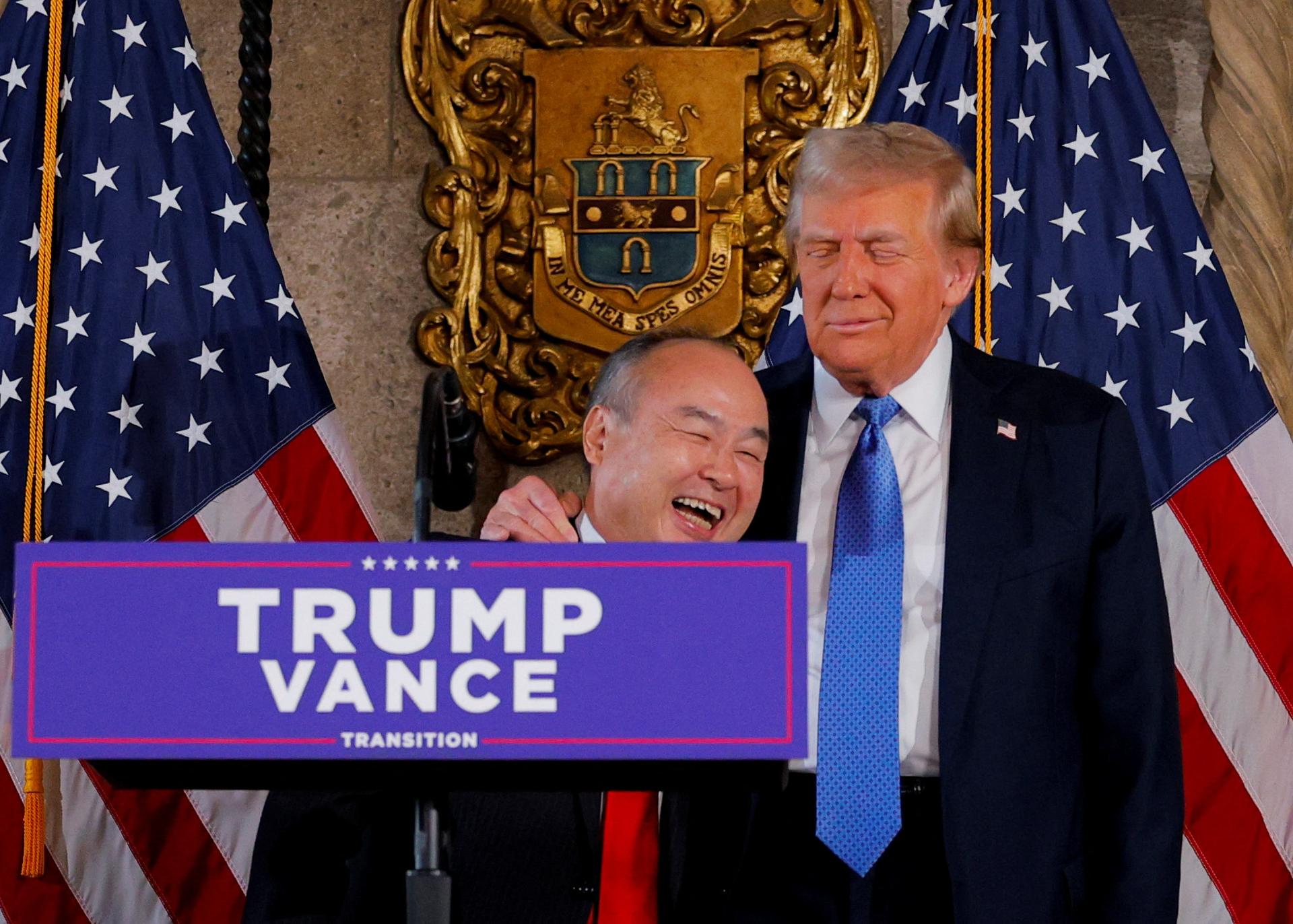 US President-elect Donald Trump embraces CEO of SoftBank Masayoshi Son at Mar-a-Lago in Palm Beach, Florida