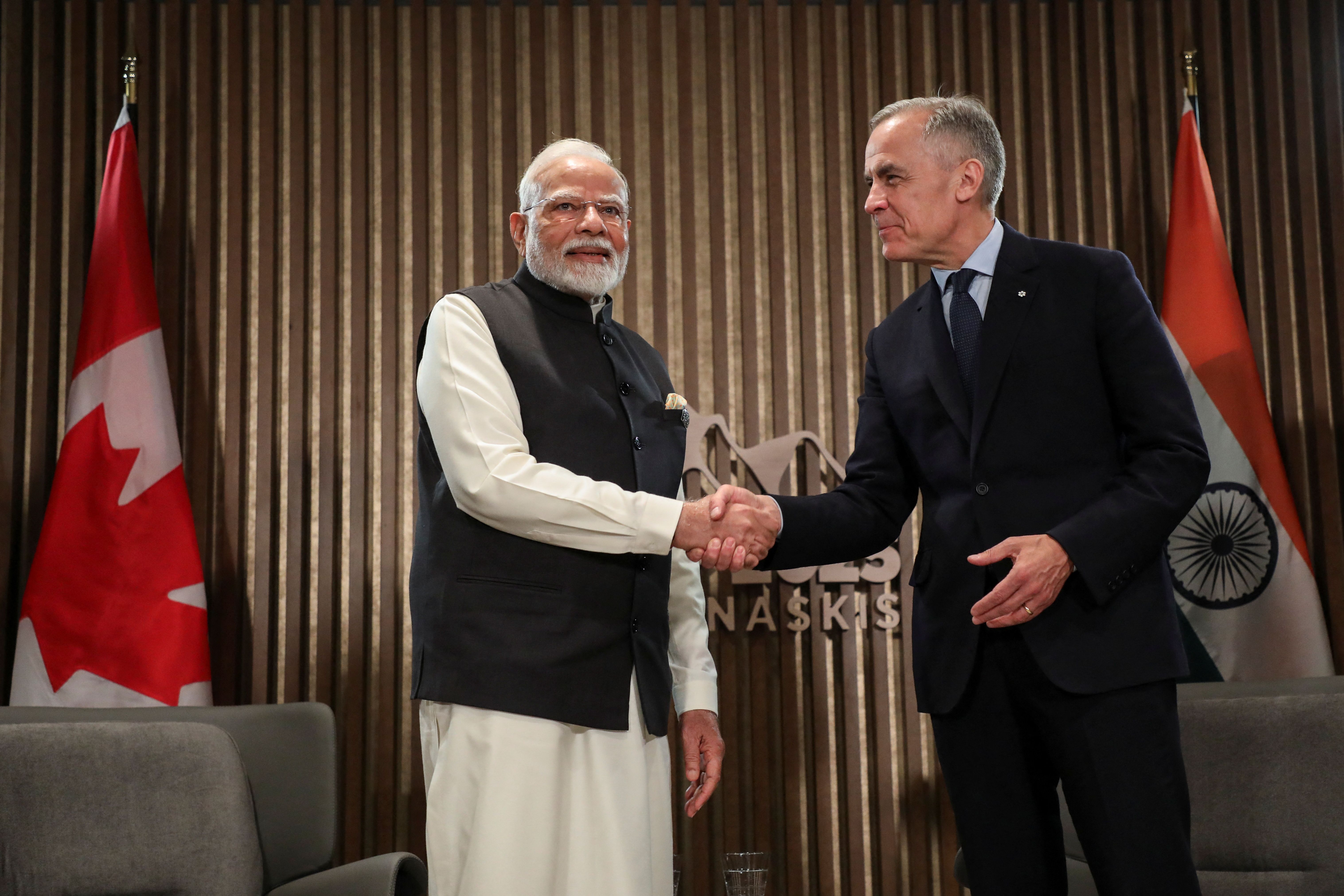 Indian Prime Minister Narendra Modi shakes hands with Canadian Prime Minister Mark Carney.