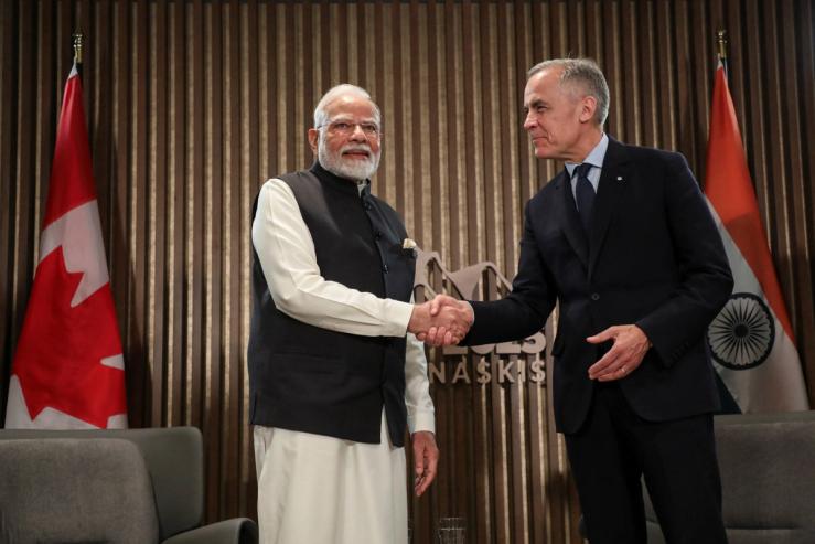 Indian Prime Minister Narendra Modi shakes hands with Canadian Prime Minister Mark Carney.