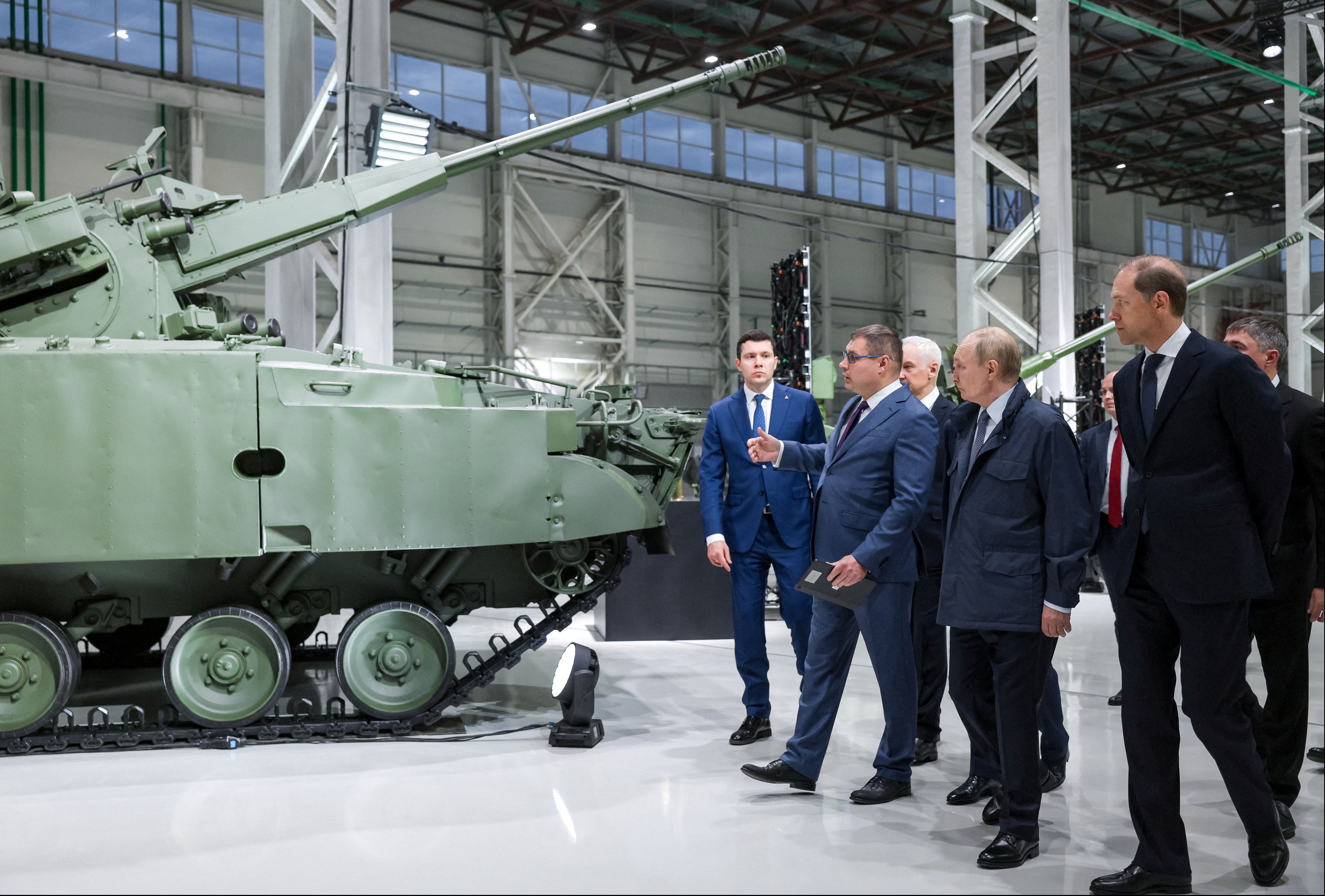 Russian President Vladimir Putin, accompanied by Minister of Industry and Trade Anton Alikhanov and First Deputy Prime Minister Denis Manturov, tours the exhibition of weapons and military equipment as he visits Motovilikha Plants in Perm, Russia