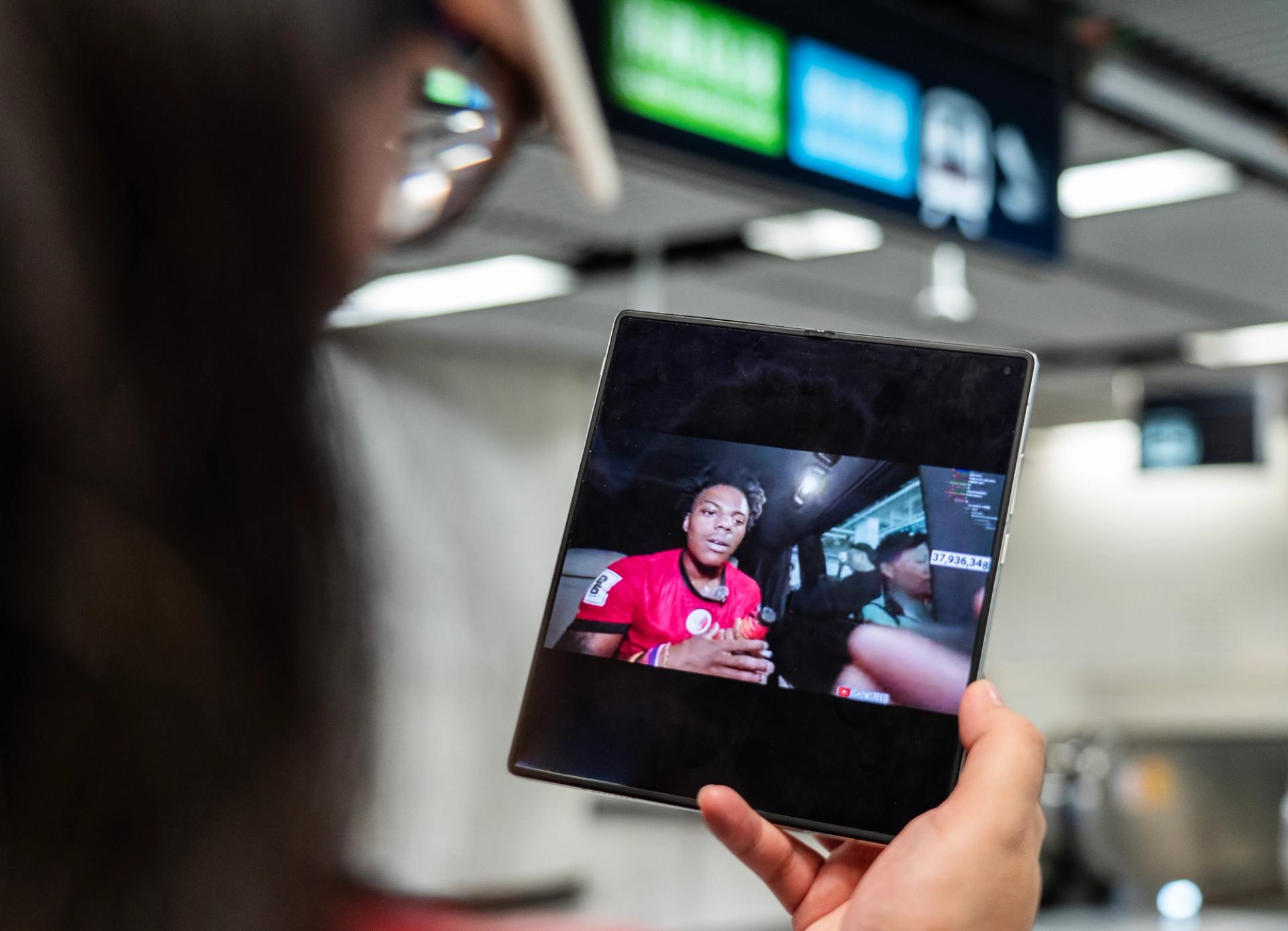 A woman watching IShowSpeed