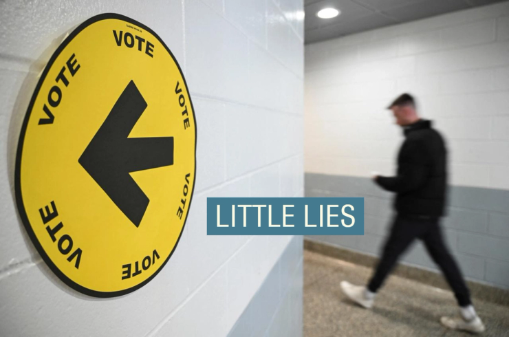 A man walks down a hallway at a polling station.
