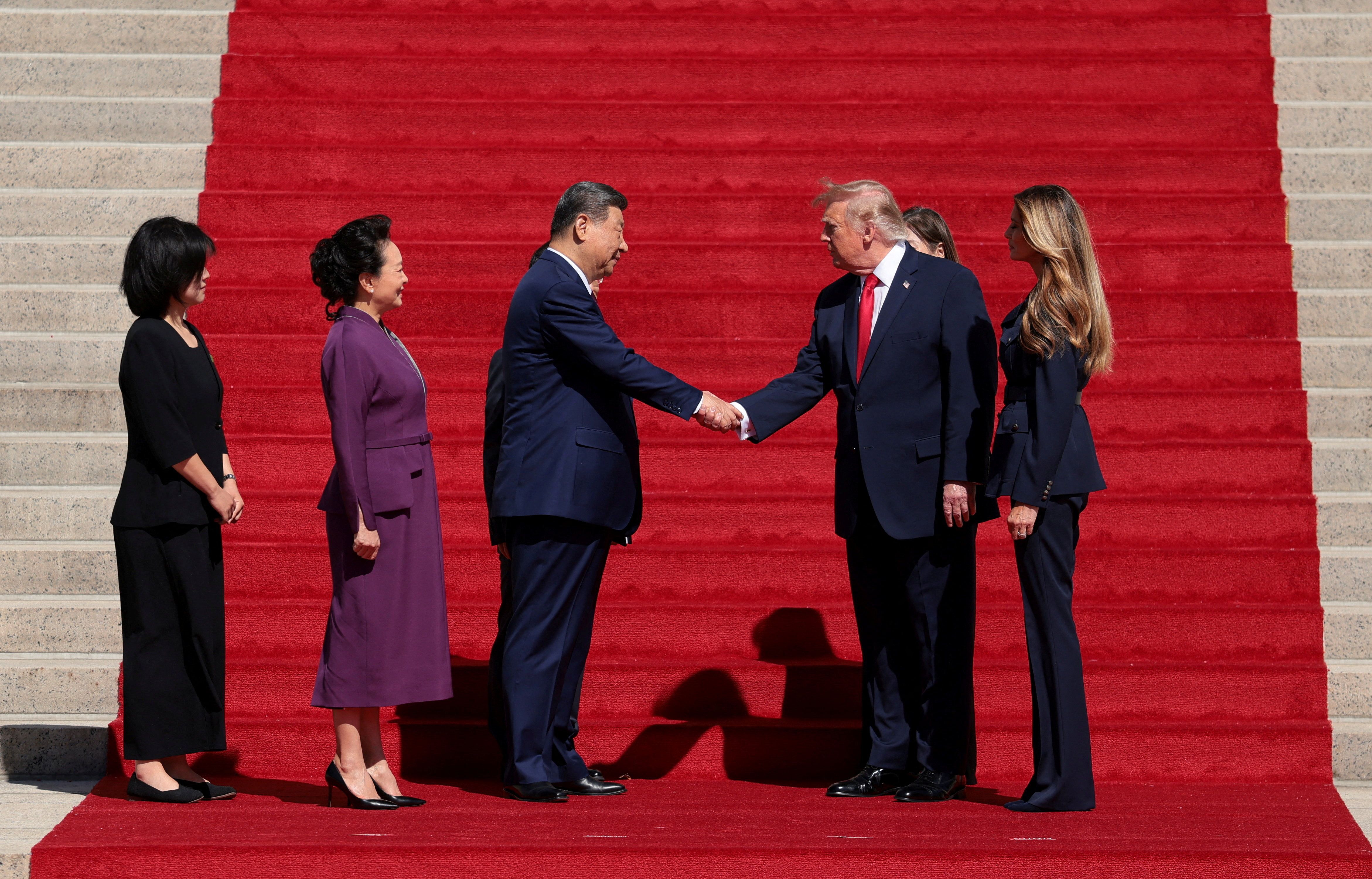 President Donald Trump and Xi Jinping shake hands