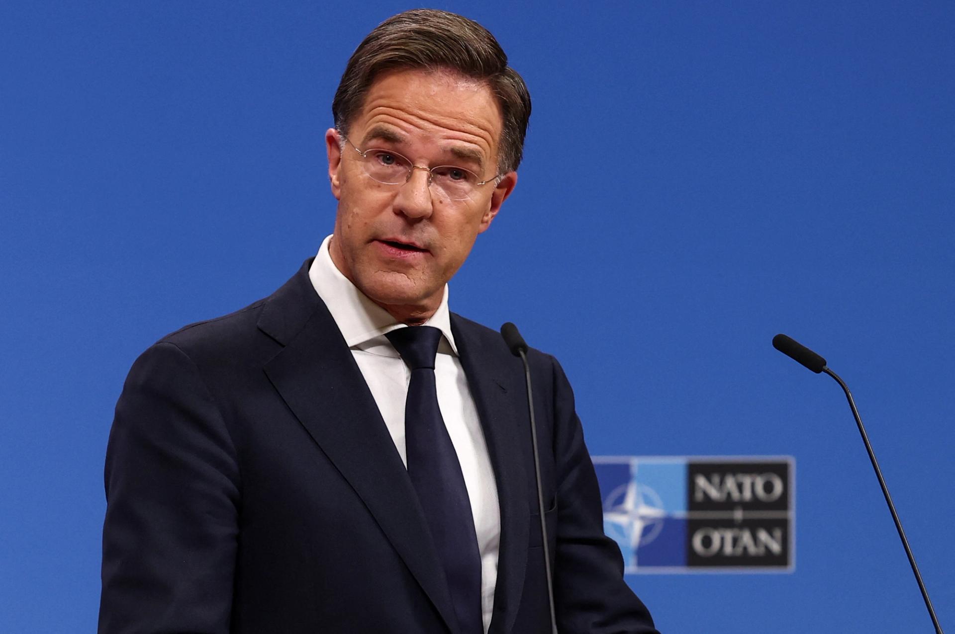 NATO Secretary-General Mark Rutte, wearing a black suit and navy tie, holds a press conference in Brussels, Belgium.