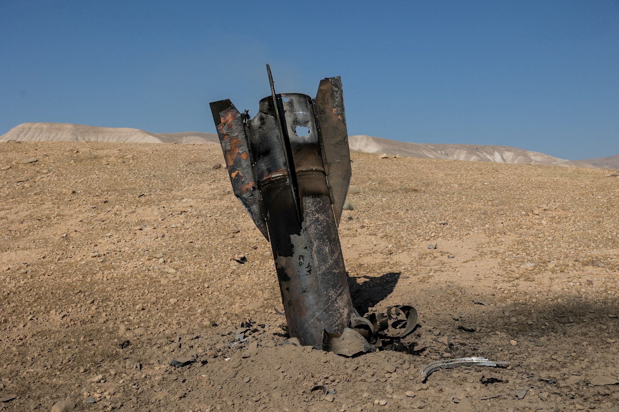 Part of a missile protrudes from the ground in the West Bank