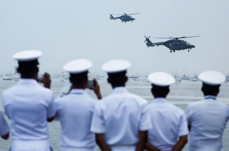 Indian Navy personnel watch a demonstration during Navy Day celebrations in Mumbai.