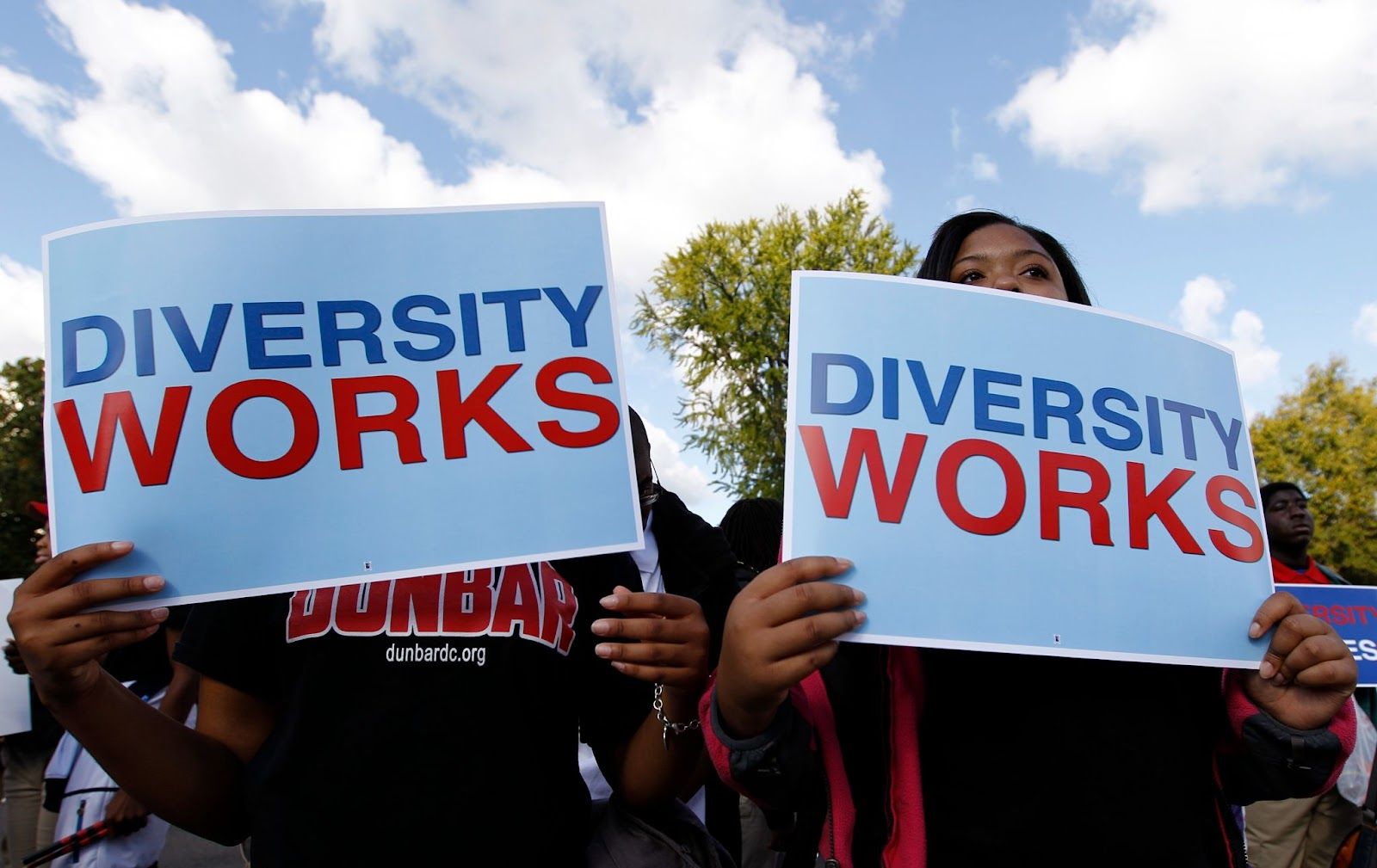 Protestors with pro-diversity signs.