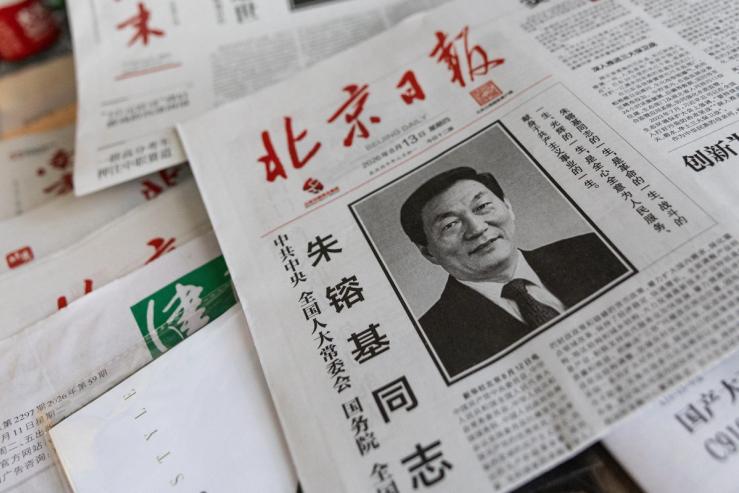 A newspaper with an obituary of late former Chinese Premier Zhu Rongji on the front, who passed away on Wednesday, is displayed at a news stand in Beijing, China, August 13, 2026.