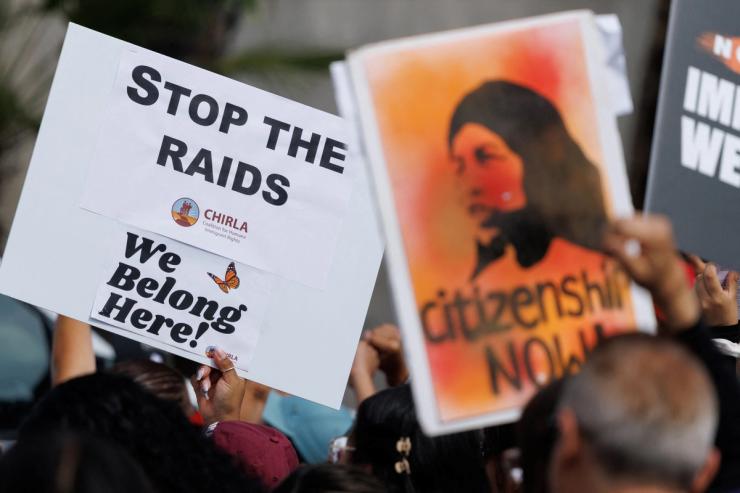 Demonstrators rally and march through MacArthur Park.