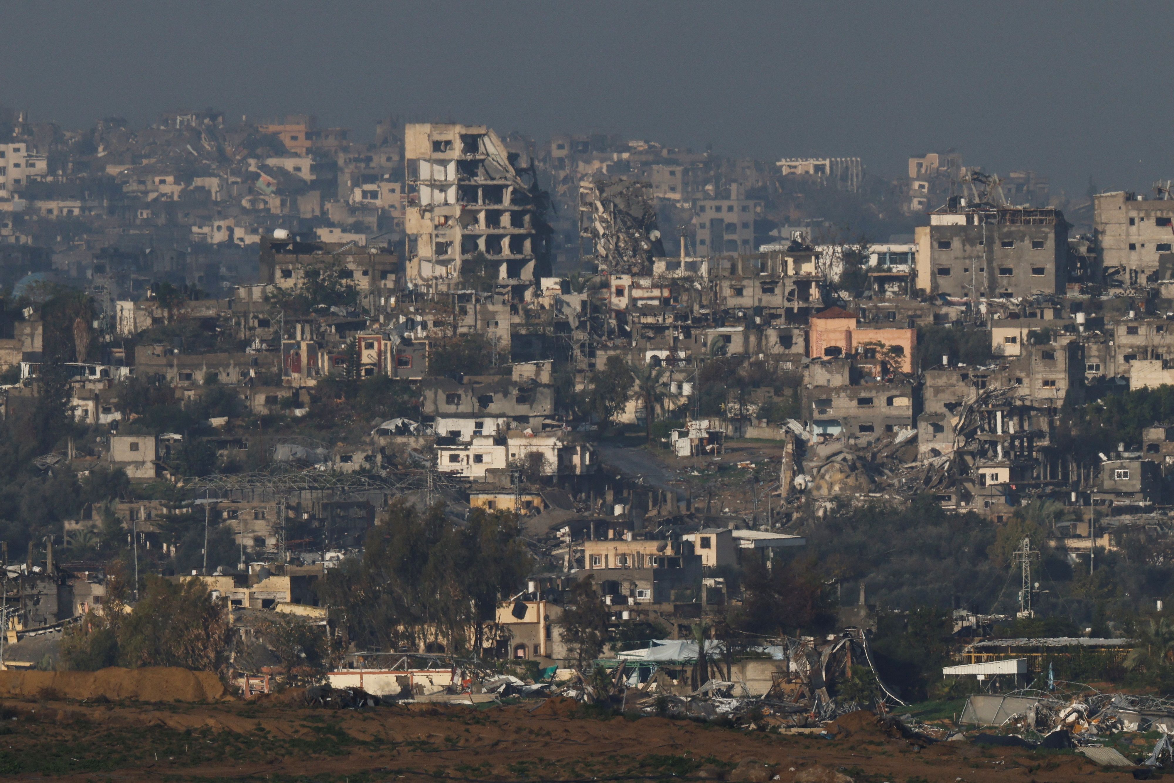 A view shows damaged buildings in Gaza, amid the ongoing conflict between Israel and the Palestinian Islamist group Hamas, as seen from Israel, January 12, 2024. REUTERS/Tyrone Siu