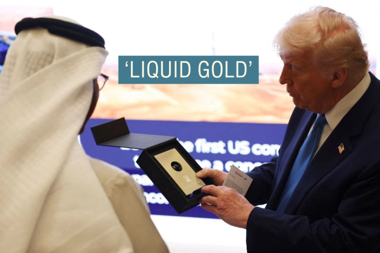 President Donald Trump holds a sample of oil that he was gifted as he attends a business forum at Qasr Al Watan during the final stop of his Gulf visit, in Abu Dhabi.