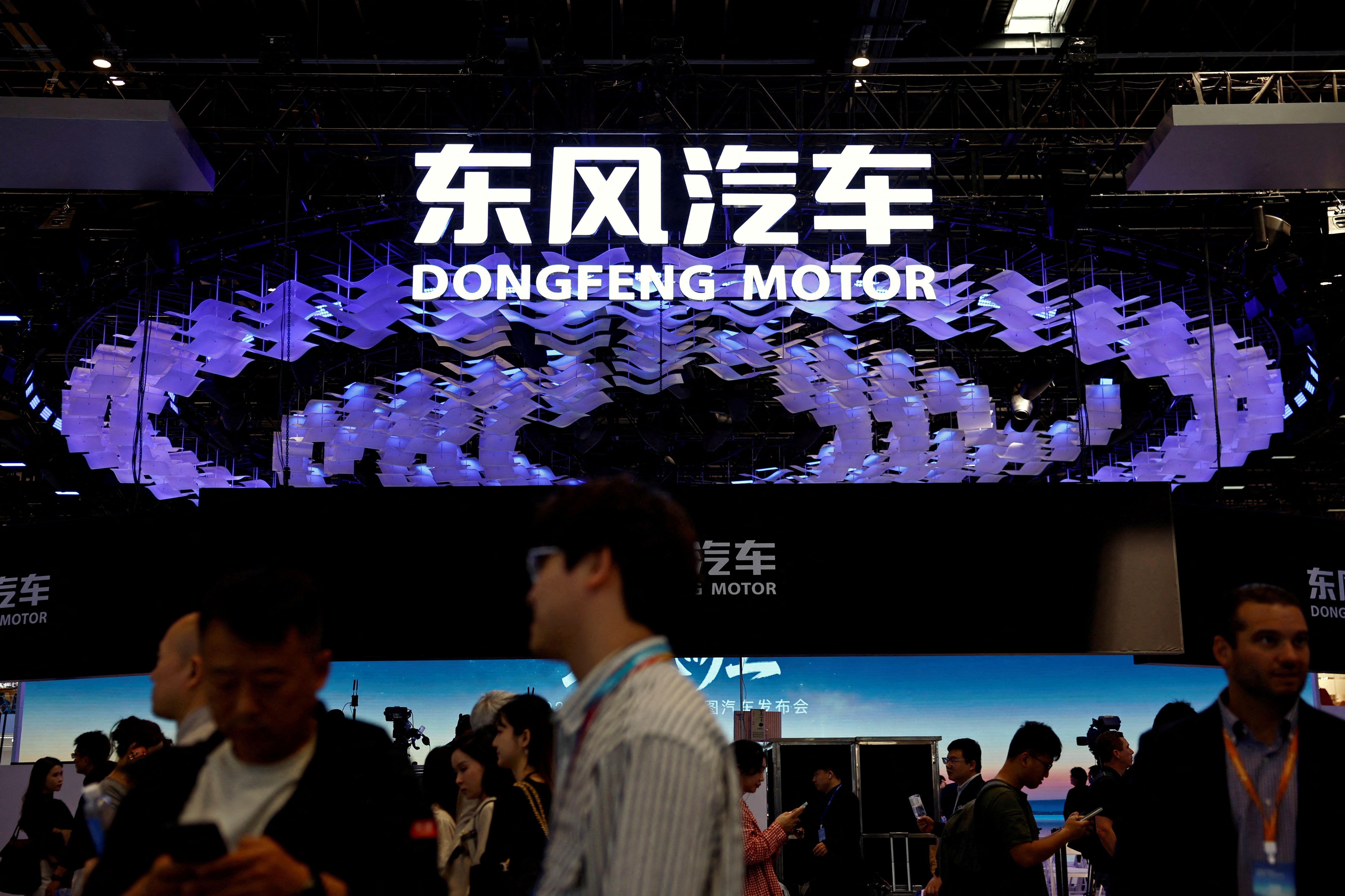 People visit the booth of carmaker Dongfeng Motor at the Beijing International Automotive Exhibition.