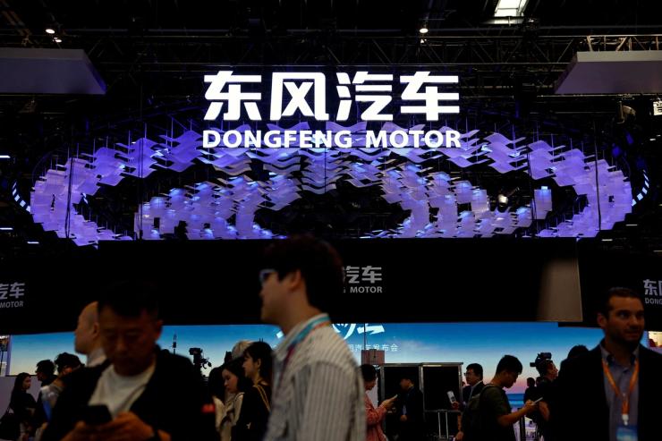 People visit the booth of carmaker Dongfeng Motor at the Beijing International Automotive Exhibition.