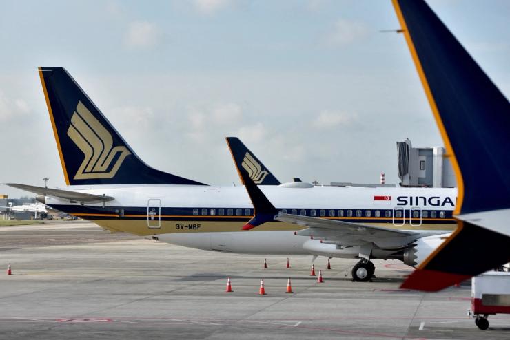 FILE PHOTO: Singapore Airlines planes sit on the tarmac at Changi Airport in Singapore November 16, 2021. REUTERS/Caroline Chia