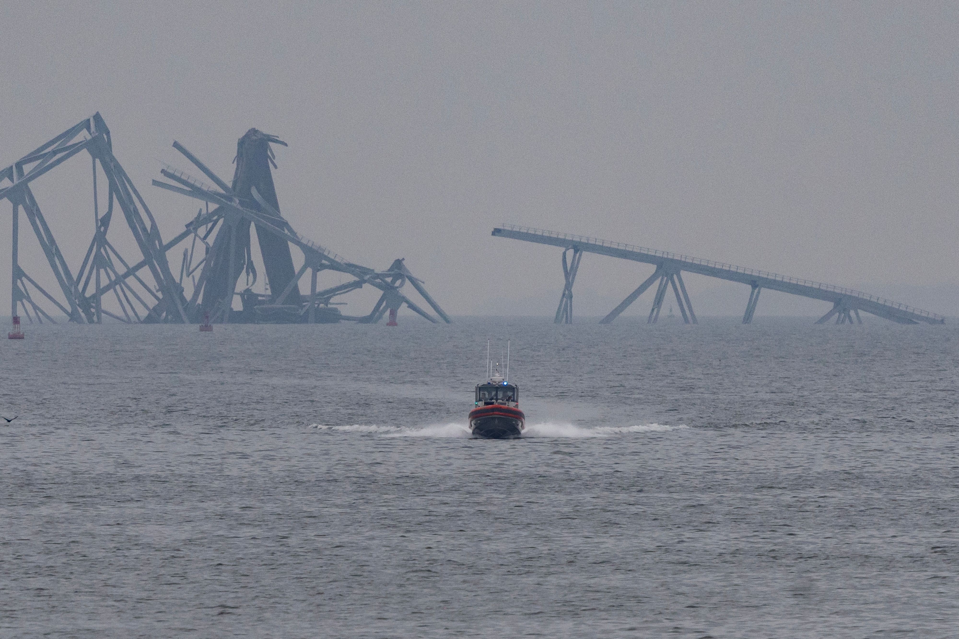 A U.S. Coast Guard patrol vessel travels along the Patapsco River on March 28 following the collapse of the Francis Scott Key Bridge.