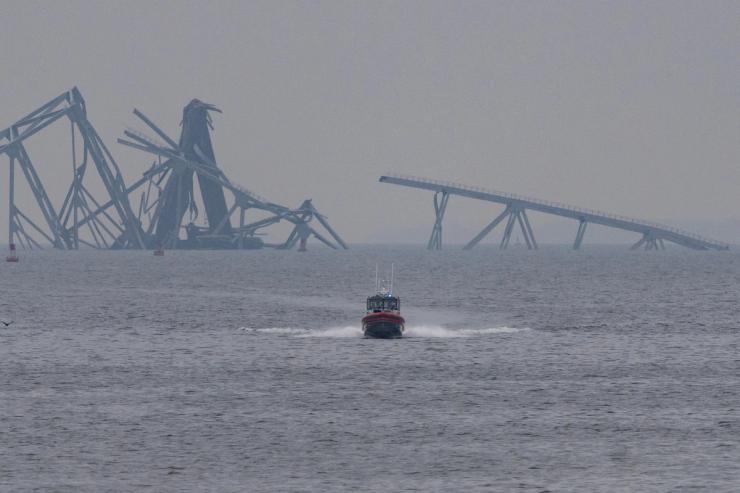 A U.S. Coast Guard patrol vessel travels along the Patapsco River on March 28 following the collapse of the Francis Scott Key Bridge.