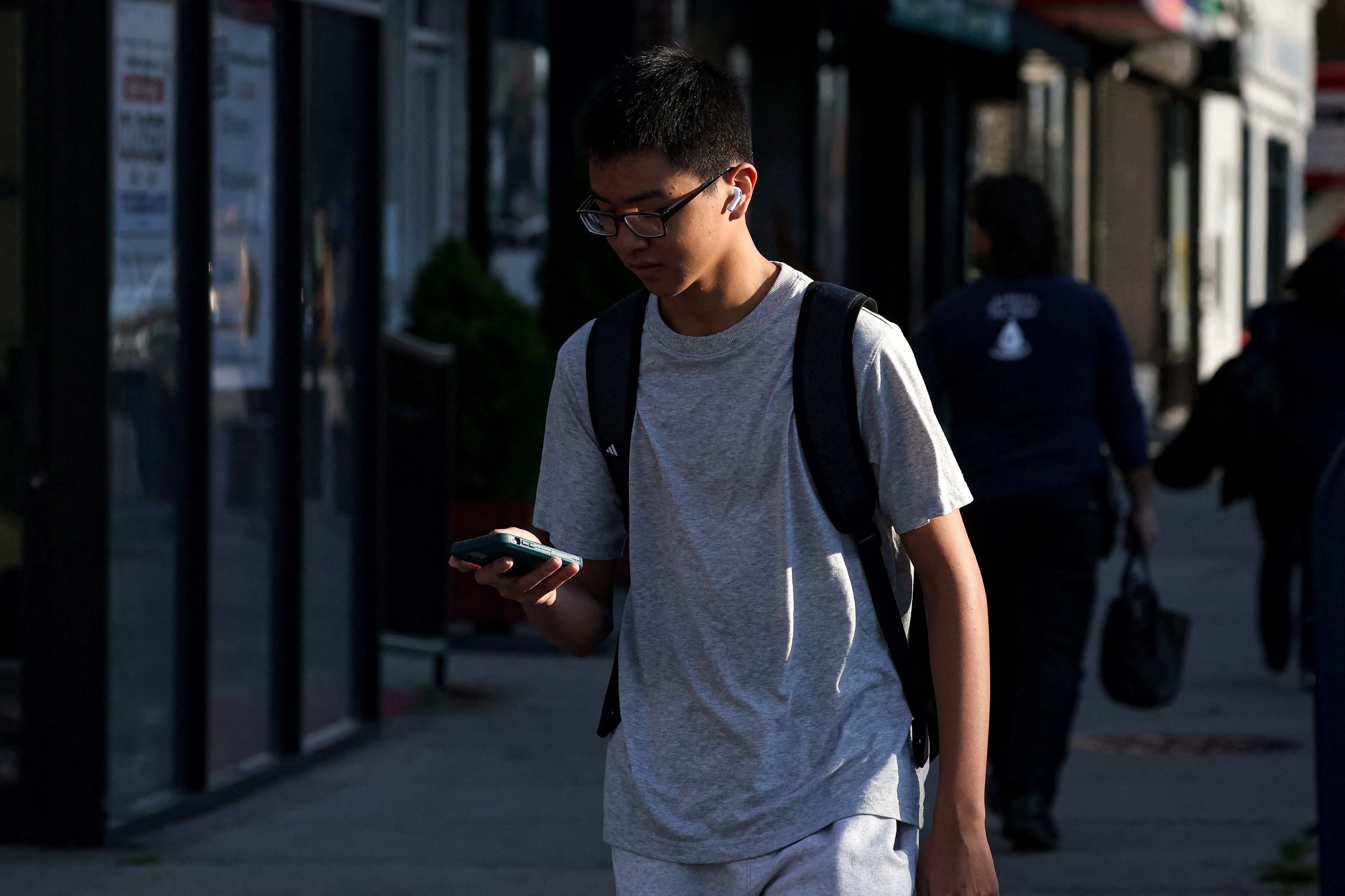 A teen looks at his phone.