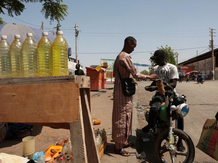 A street vendor sells petrol to a motorcyclist in Cameroon, March 22, 2026