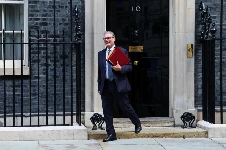 British Prime Minister Keir Starmer walks outside 10 Downing Street in London