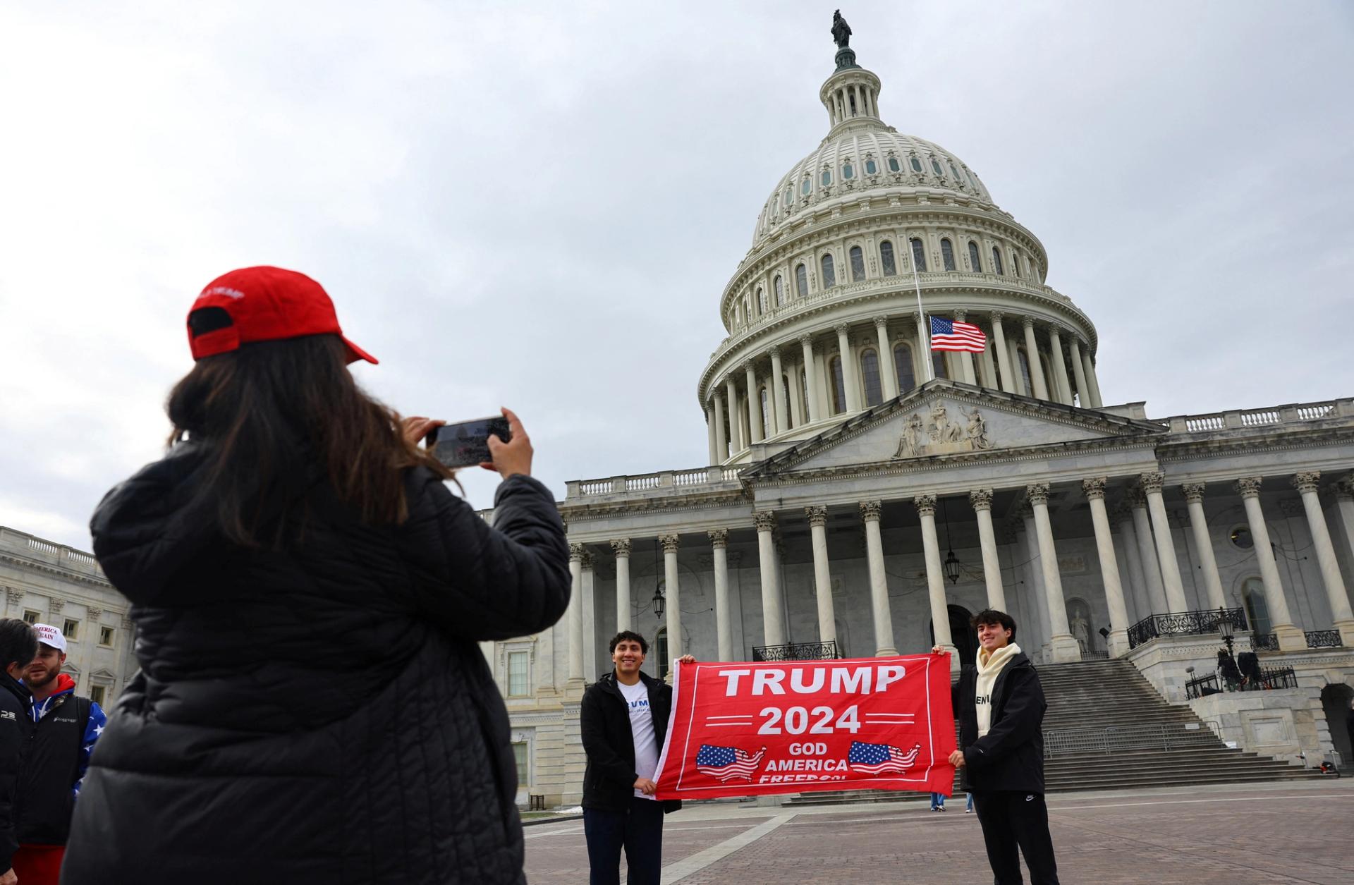 US President-elect Donald Trump supports hold up a banner in his support in front of the US Capitol building ahead of the presidential inauguration.