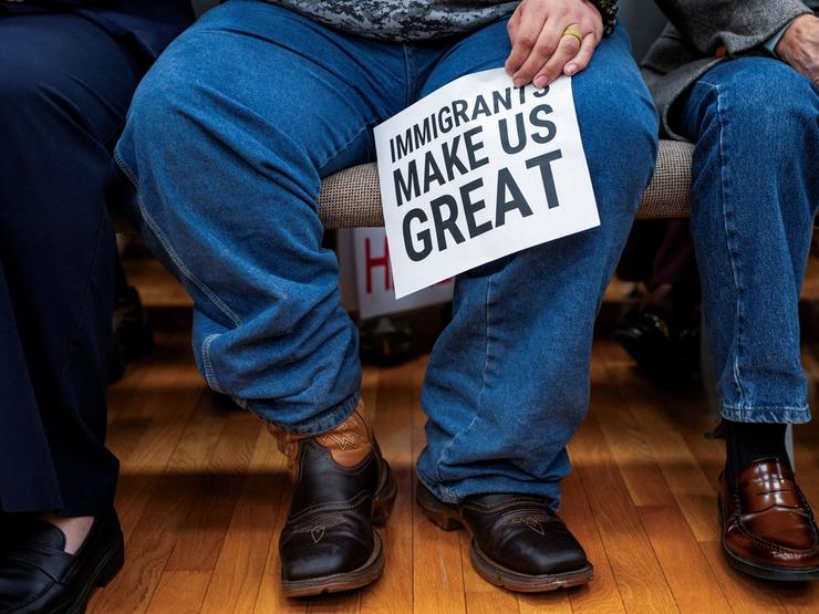 Person holding a pro-immigrant sign