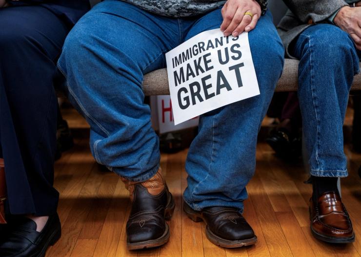 Person holding a pro-immigrant sign