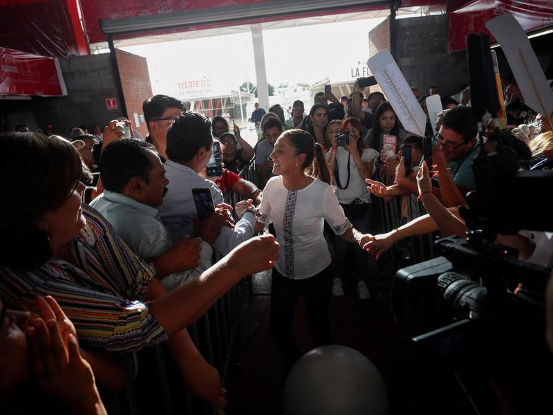Former Mexico City Mayor Claudia Sheinbaum greets people as she arrives for an event in Guadalupe, Mexico.