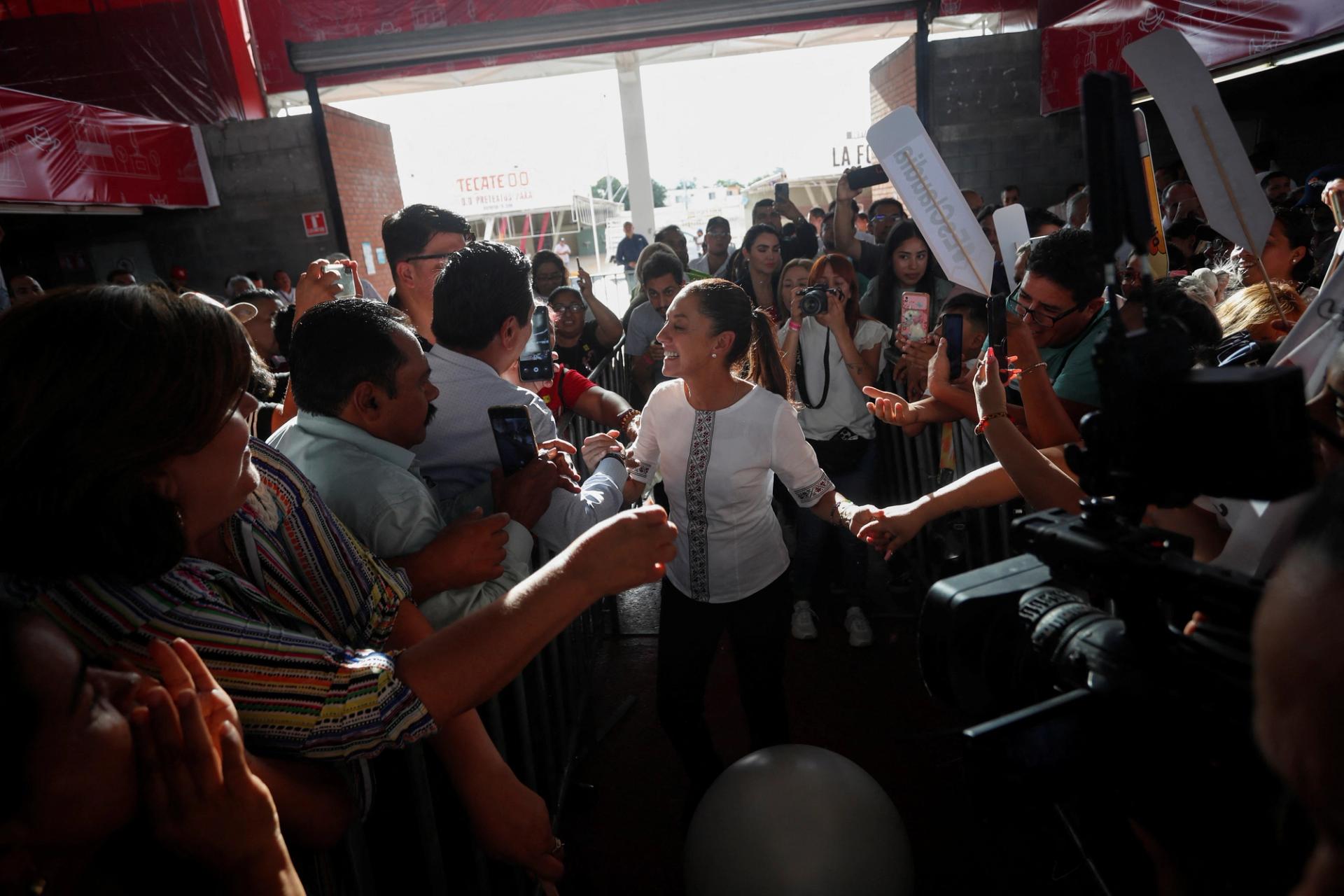 Former Mexico City Mayor Claudia Sheinbaum greets people as she arrives for an event in Guadalupe, Mexico.