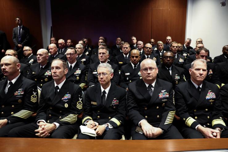 Members of the military listen to US President Donald Trump as they attend a meeting convened by US Defense Secretary Pete Hegseth.