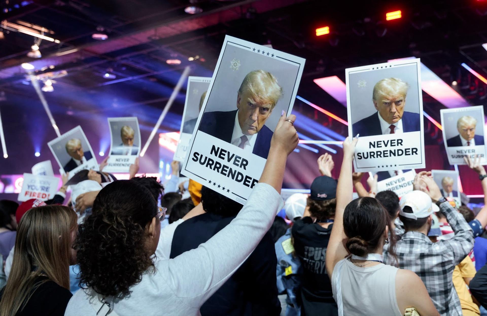 Attendees hold up ‘Never Surrender’ posters as Republican presidential candidate Donald Trump speaks at an event held by the national conservative political movement, “Turning Point”, in Detroit, Michigan, on June 15, 2024. 