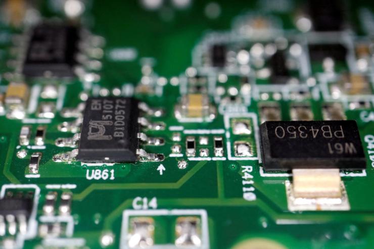 Semiconductor chips are seen on a printed circuit board.