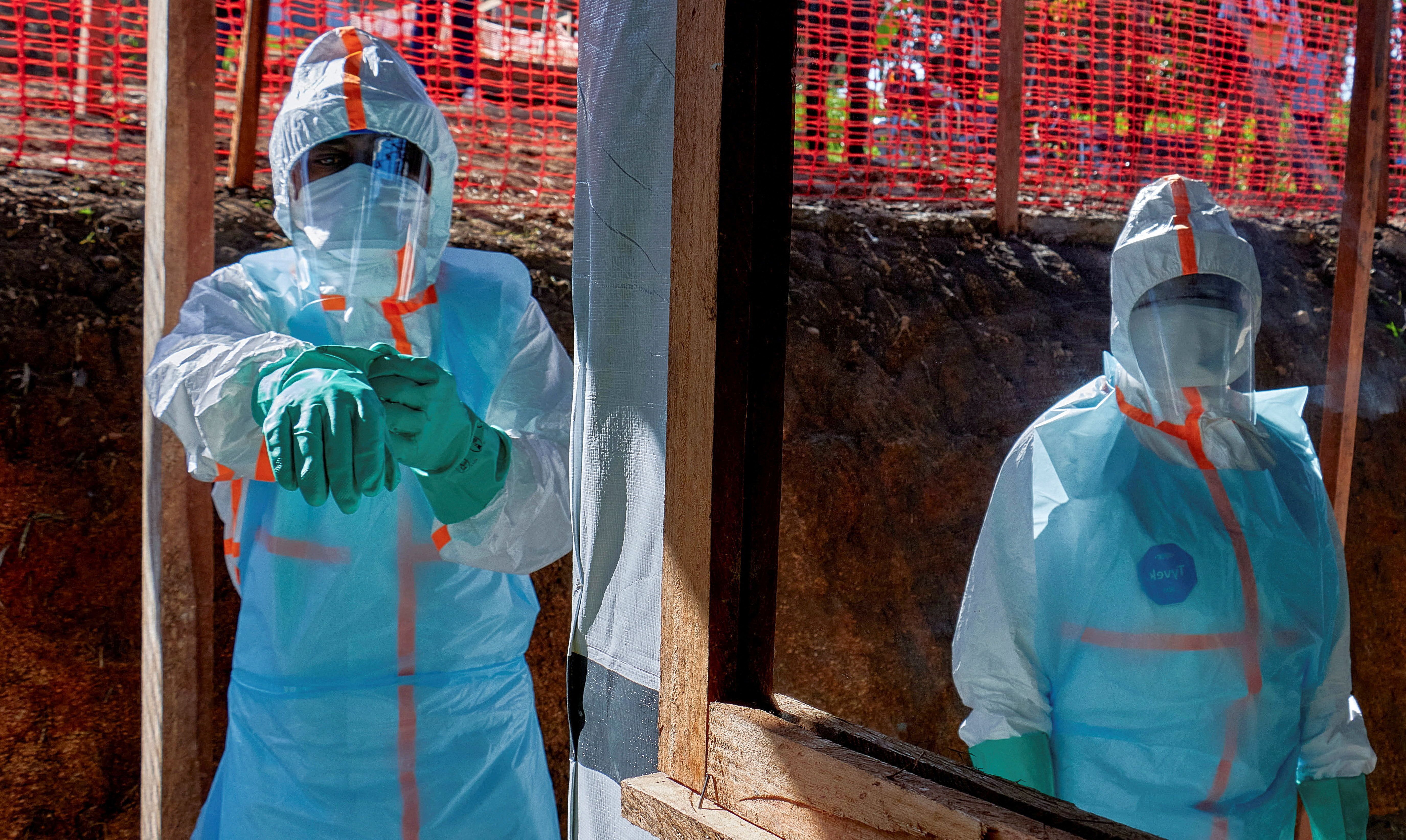 Health workers get dressed in personal protective equipment in the DRC