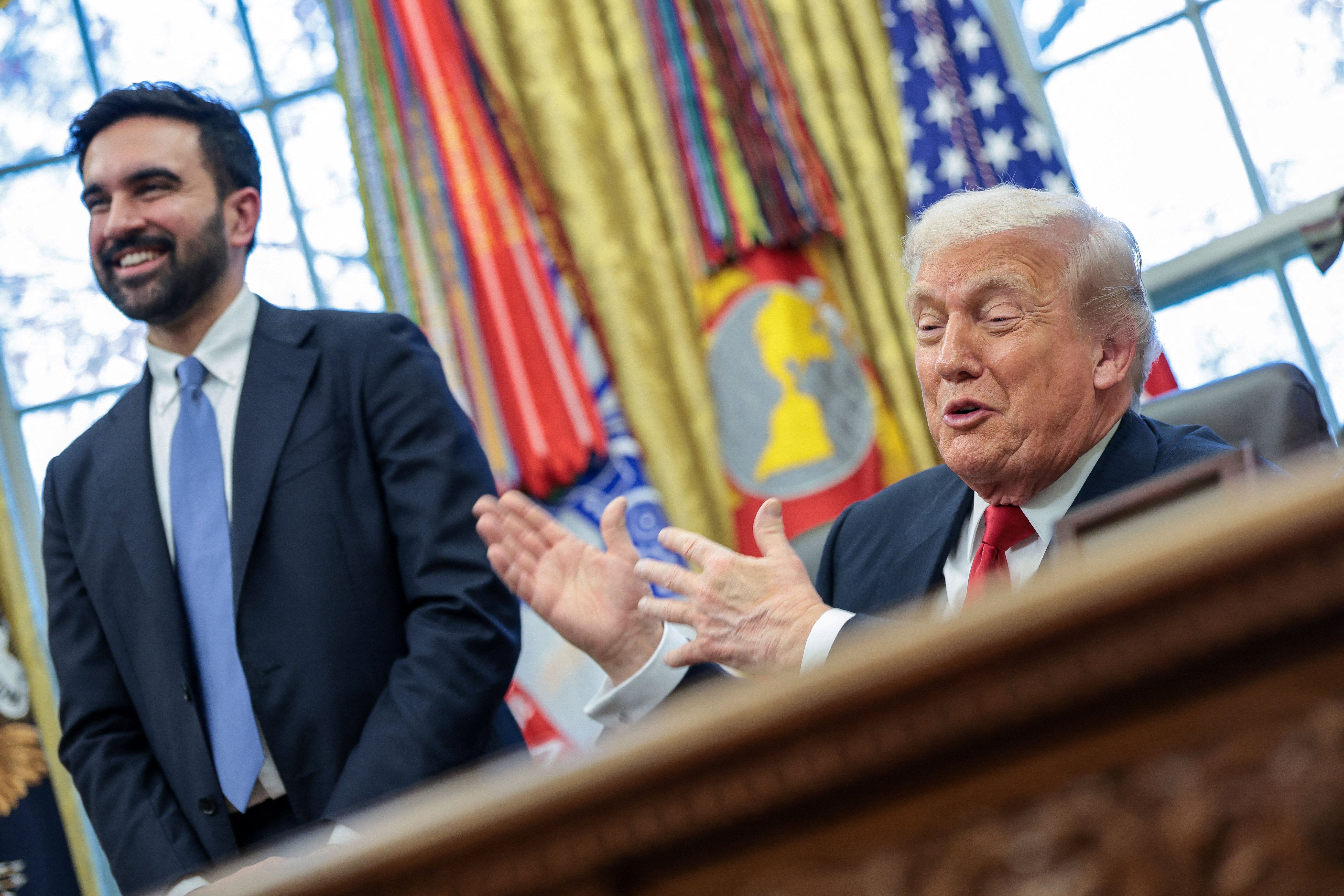 US President Donald Trump and New York City Mayor-elect Zohran Mamdani react as they speak to members of the media in the Oval Office at the White House in Washington, DC