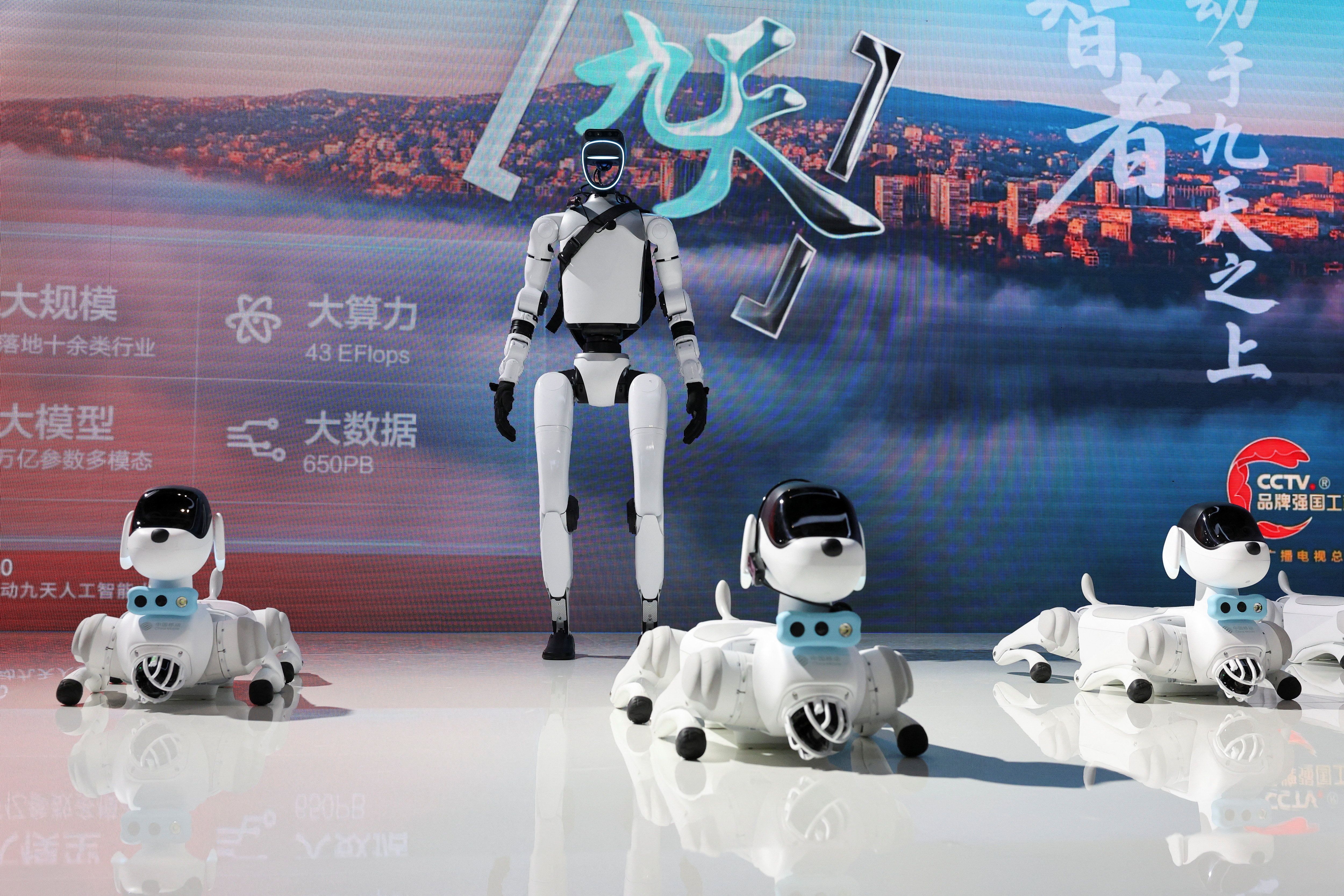 A humanoid robot and robot dogs are displayed at China Mobile booth during WAIC in Shanghai.