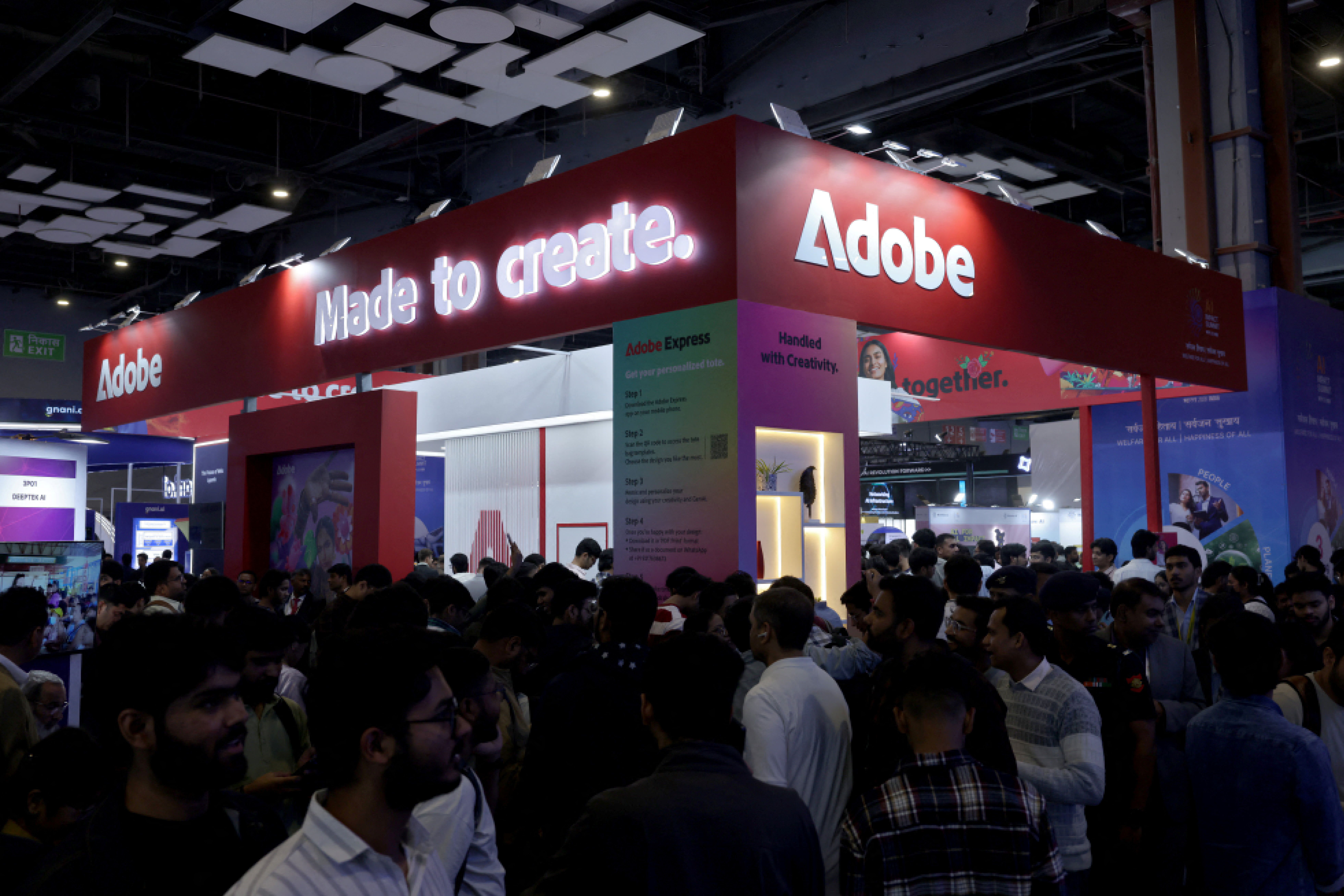 Visitors gather near a stall of Adobe