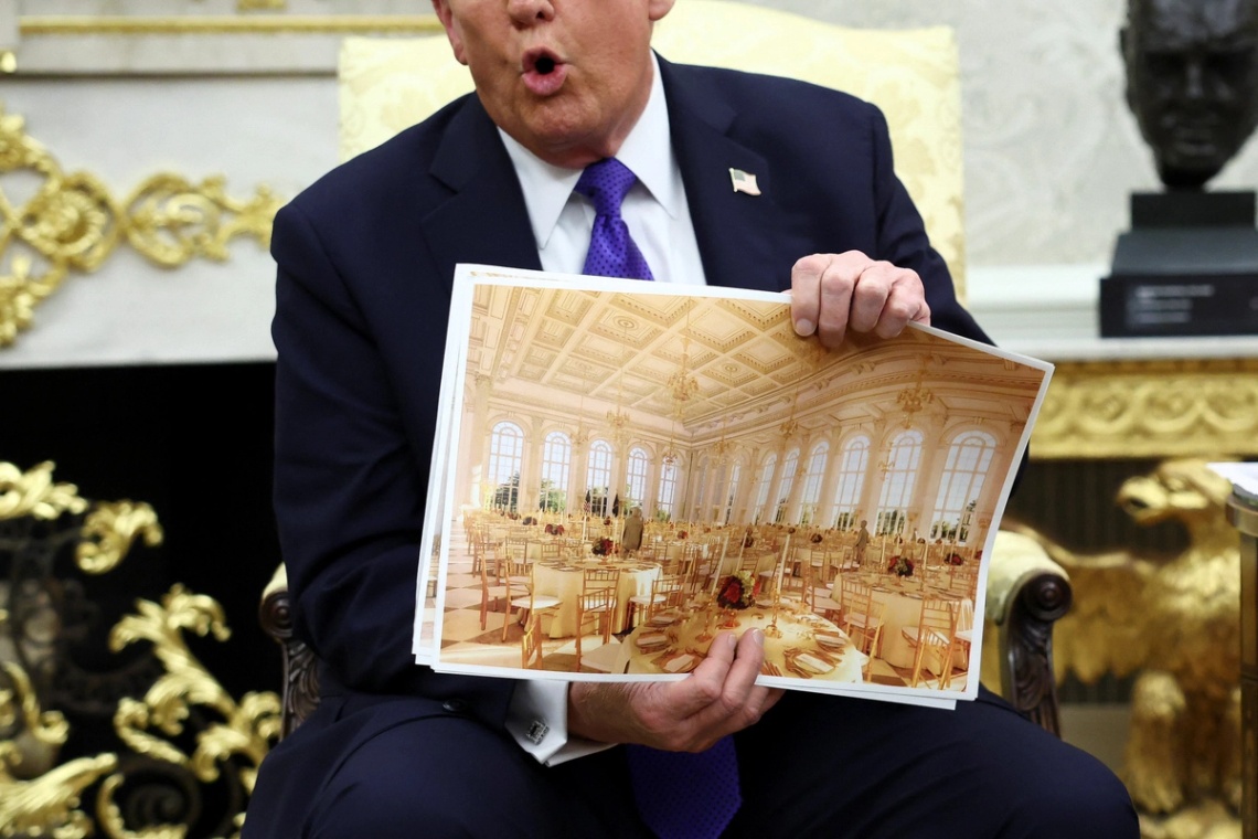 Trump holds a rendering of the new White House ballroom under construction